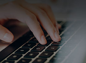 A person typing on the laptop keyword 